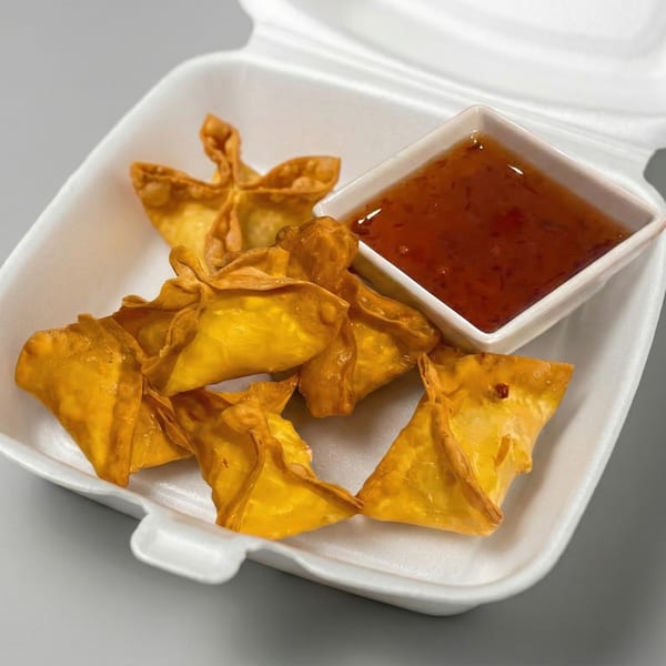 Golden-fried crab rangoons and a small dish of sweet chili sauce in a white takeout container.